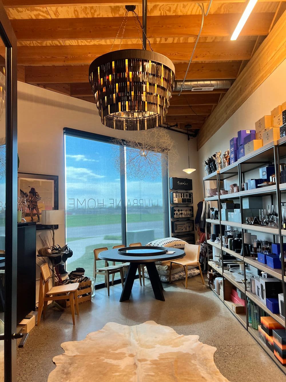 Modern interior of a stylish home decor store featuring a unique chandelier and stylish displays.