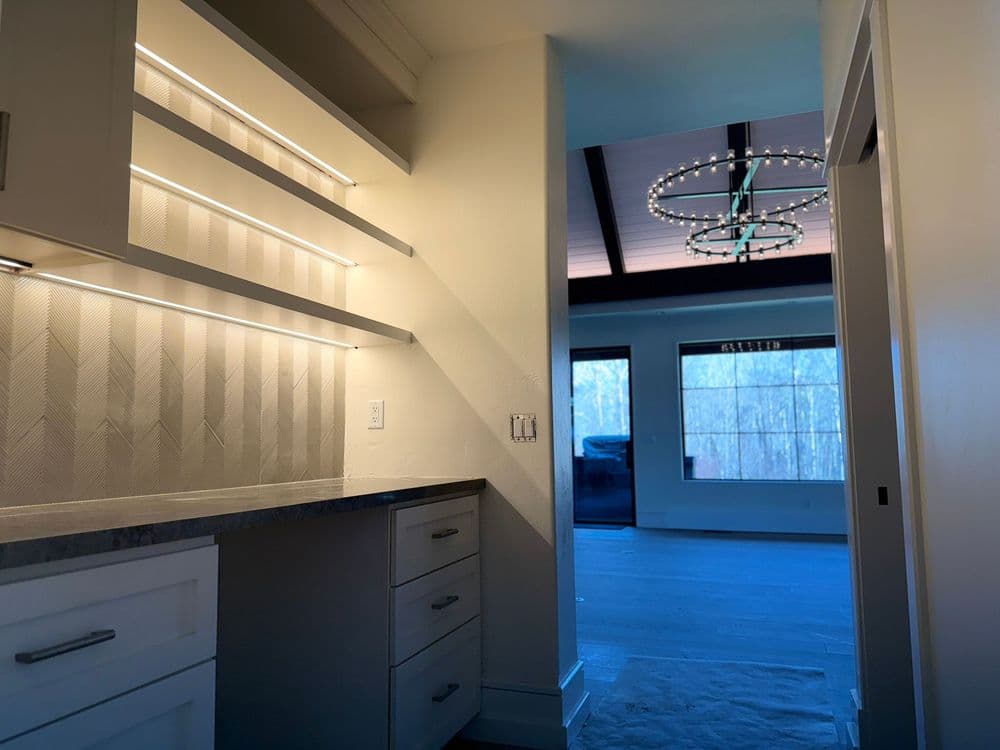 Modern kitchen with elegant cabinetry, under-cabinet lighting, and open layout.